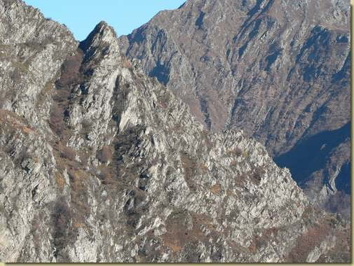 teleobiettivo dalla dorsale  sopra Curt Lùar, si vede il percorso della cengia e il canale dello Scatun...